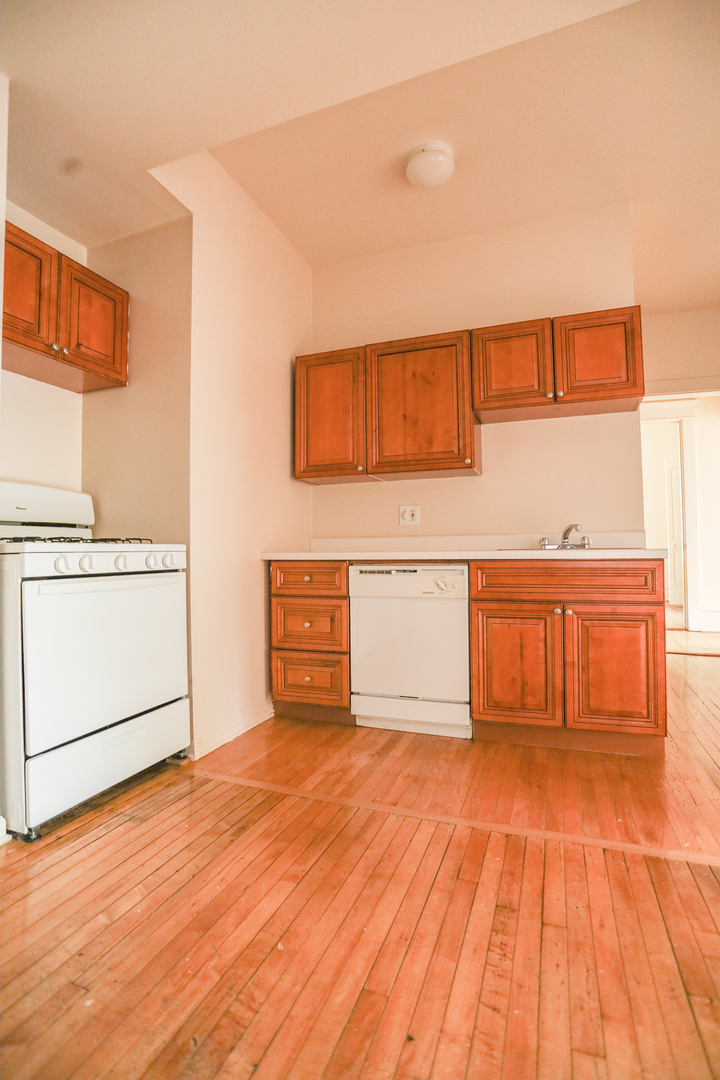 3500 North Reta Avenue, Unit 2 Chicago, IL 60657 - Photo 6 of 12 a view of a kitchen with stainless steel appliances wooden floor
