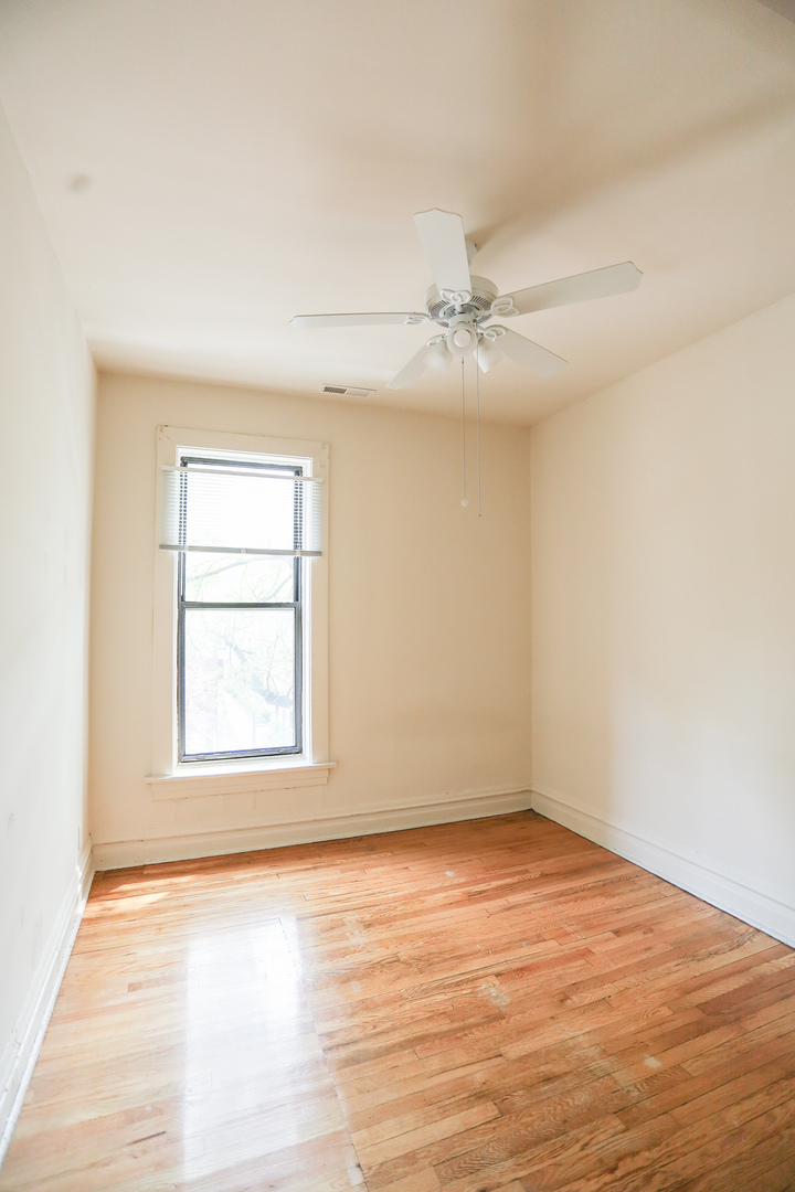 3500 North Reta Avenue, Unit 2 Chicago, IL 60657 - Photo 7 of 12 an empty room with wooden floor fan and windows