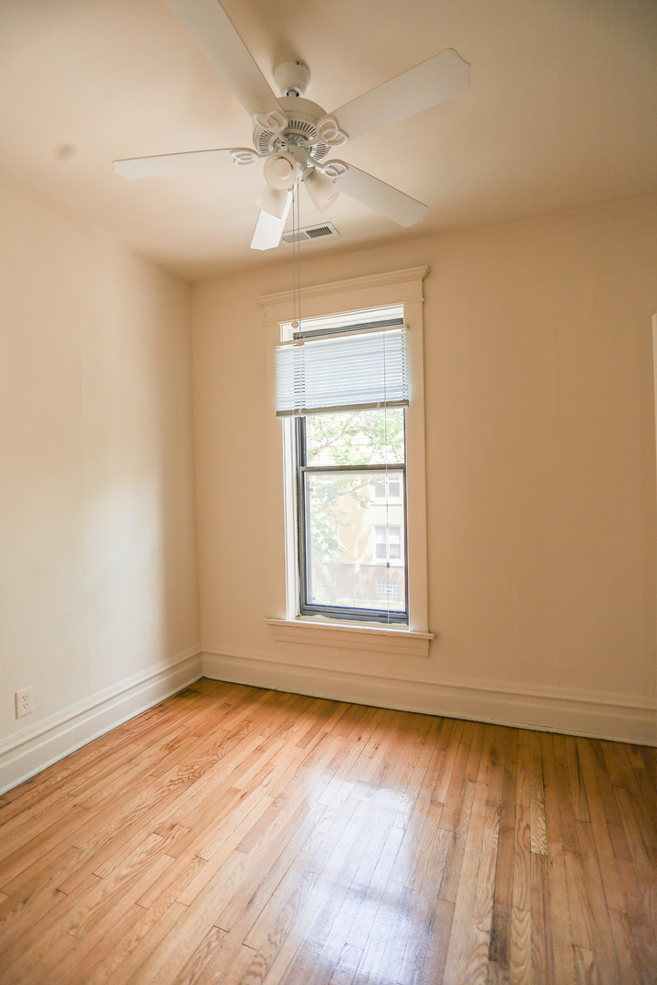 3500 North Reta Avenue, Unit 2 Chicago, IL 60657 - Photo 10 of 12 an empty room with wooden floor and windows