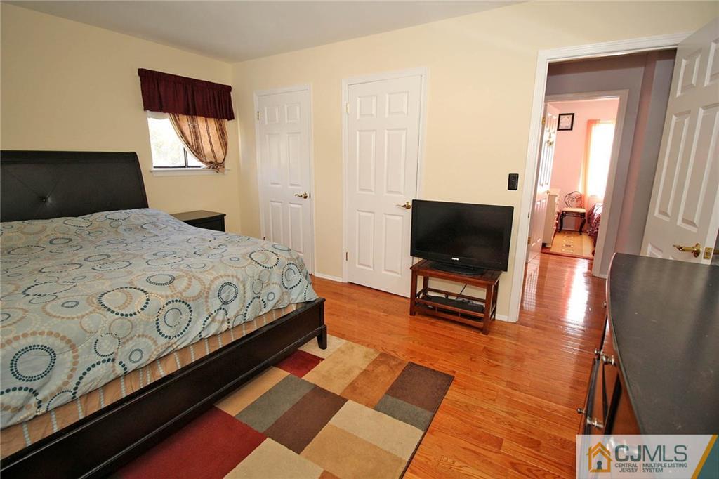 102 Running Brook Road Ewing, NJ 08638 - Photo 14 of 24 a bedroom with a bed and flat screen tv