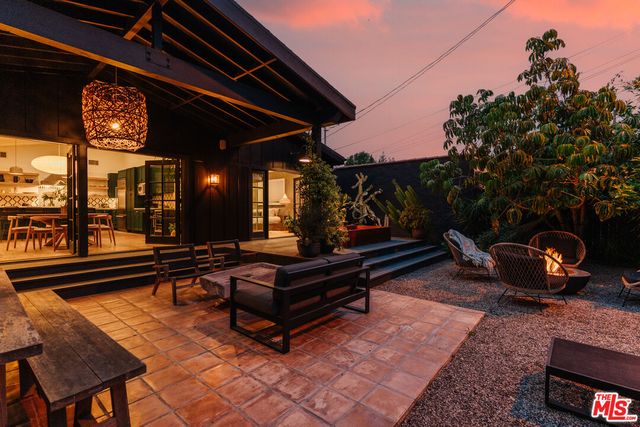 a view of a patio with table and chairs potted plants with wooden floor