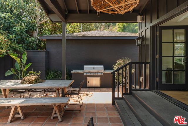 a view of a patio with table and chairs and potted plants