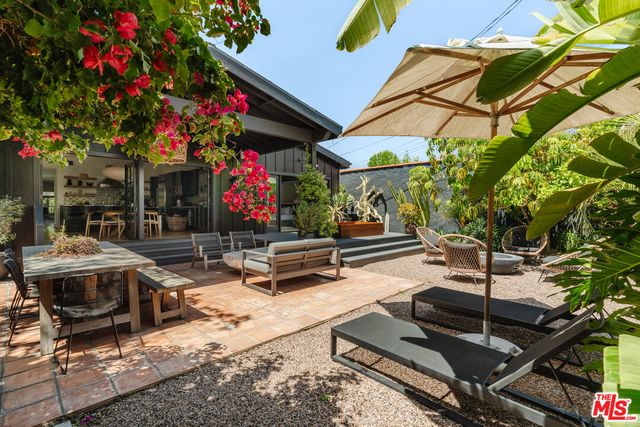 a table and chairs sitting in a backyard