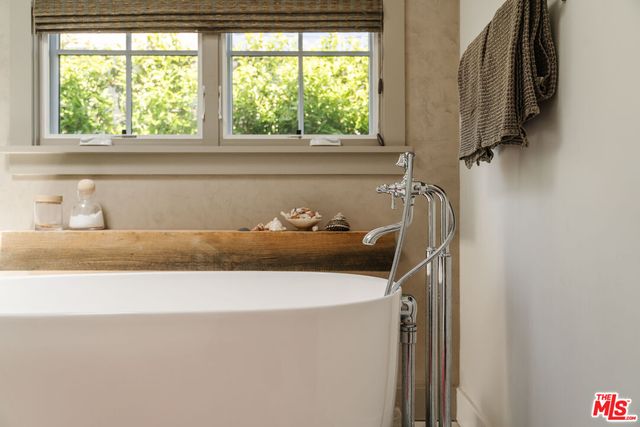 a bathroom with a window and a bathtub