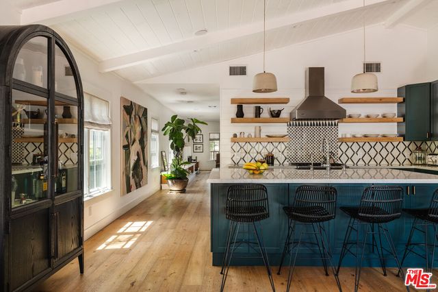 a kitchen with granite countertop a stove and a sink