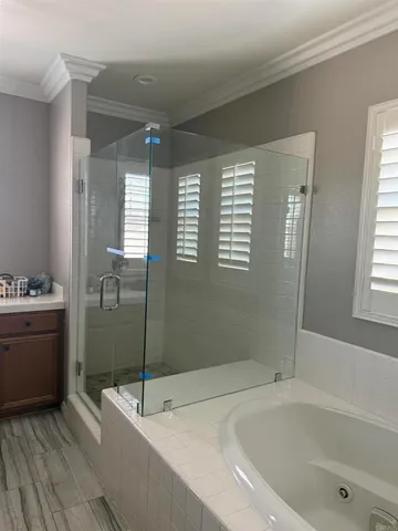 a kitchen that has a lot of cabinets in it with stainless steel appliances a dining table and chairs