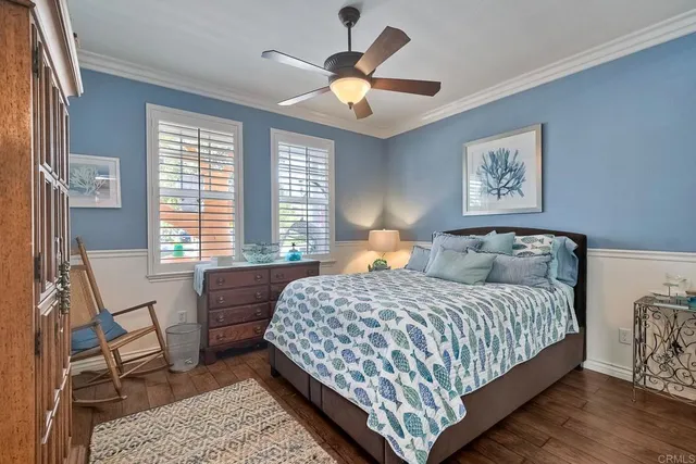 a living room with furniture potted plant kitchen view and a window