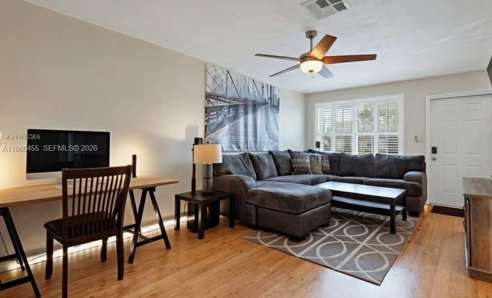 8069 Southwest 19th Court Davie, FL 33324 - Photo 3 of 14 a living room with furniture a flat screen tv and a window