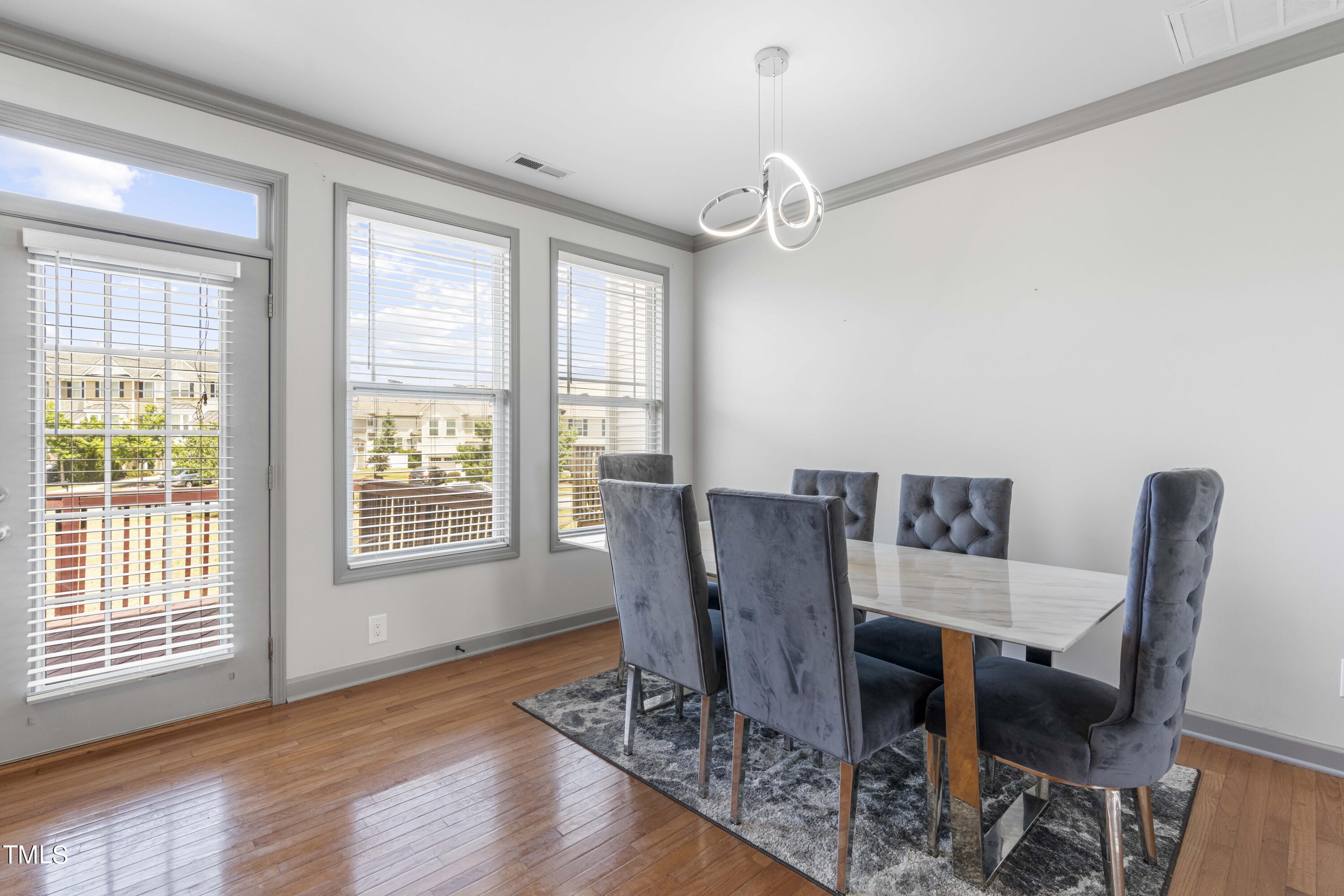 4419 Iyar Way Wake Forest, NC 27587 - Photo 11 of 26 a view of a dining room with furniture window and wooden floor
