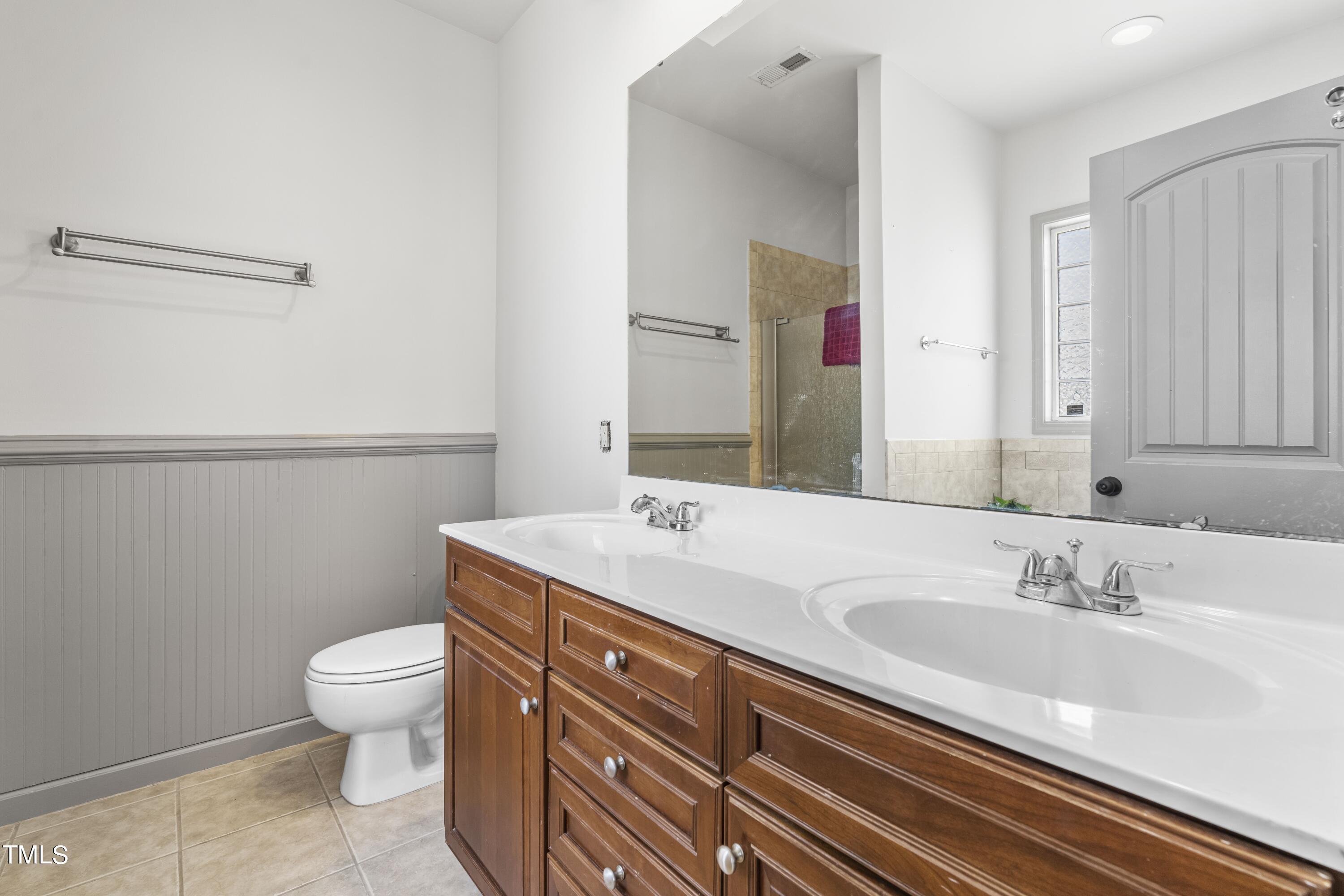 4419 Iyar Way Wake Forest, NC 27587 - Photo 18 of 26 a bathroom with a sink a toilet and a mirror