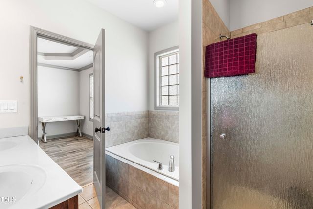 a bathroom with a tub and a shower