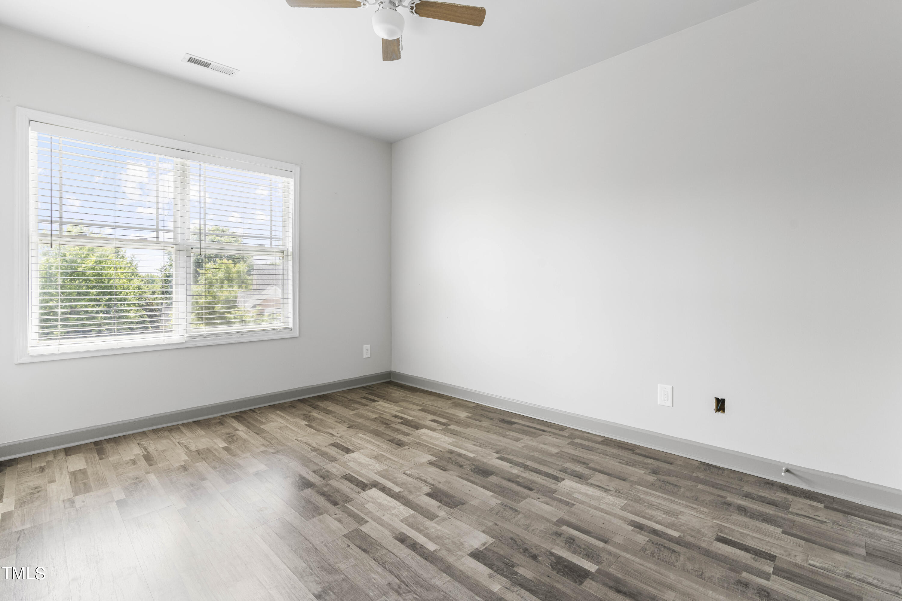4419 Iyar Way Wake Forest, NC 27587 - Photo 22 of 26 an empty room with wooden floor and windows