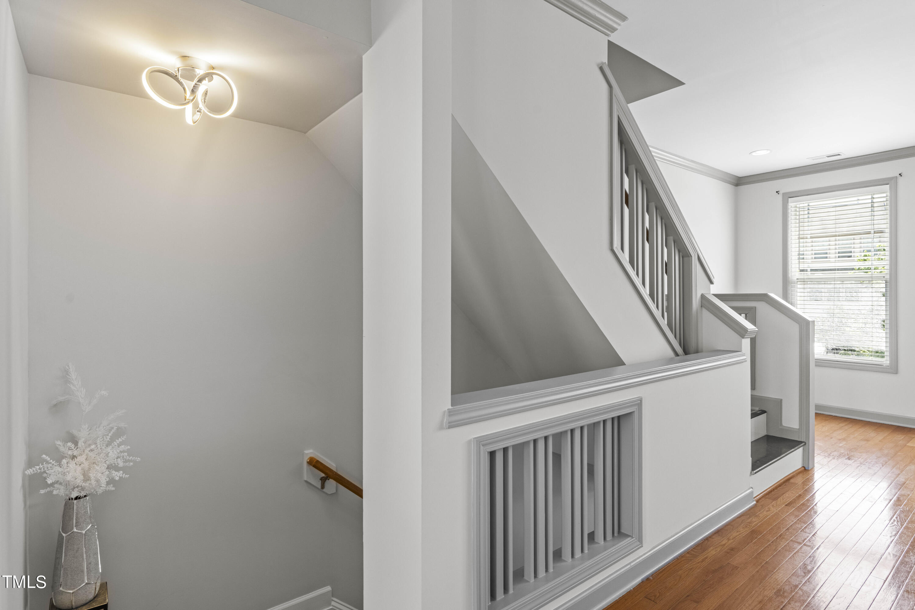 4419 Iyar Way Wake Forest, NC 27587 - Photo 7 of 26 a view of staircase with lots of frames on wall and wooden floor