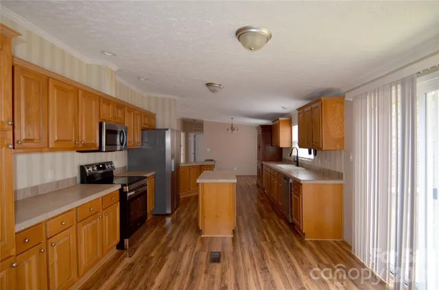 a kitchen with stainless steel appliances a refrigerator stove and sink