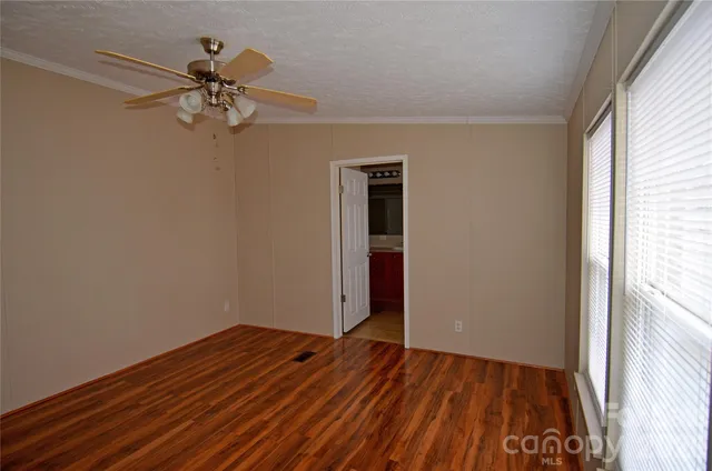 a view of room with hardwood floor and ceiling fan