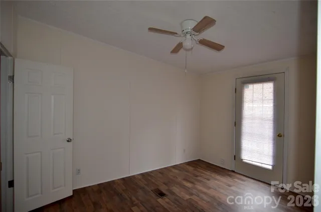 an empty room with windows and closet
