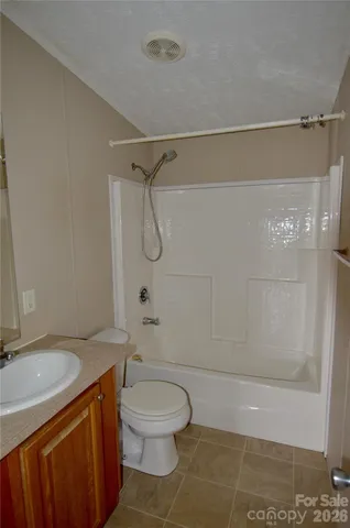 a bathroom with a shower a toilet and a sink