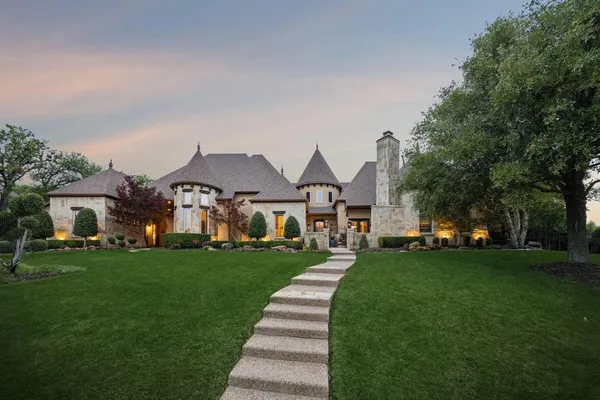 a front view of a house with a garden