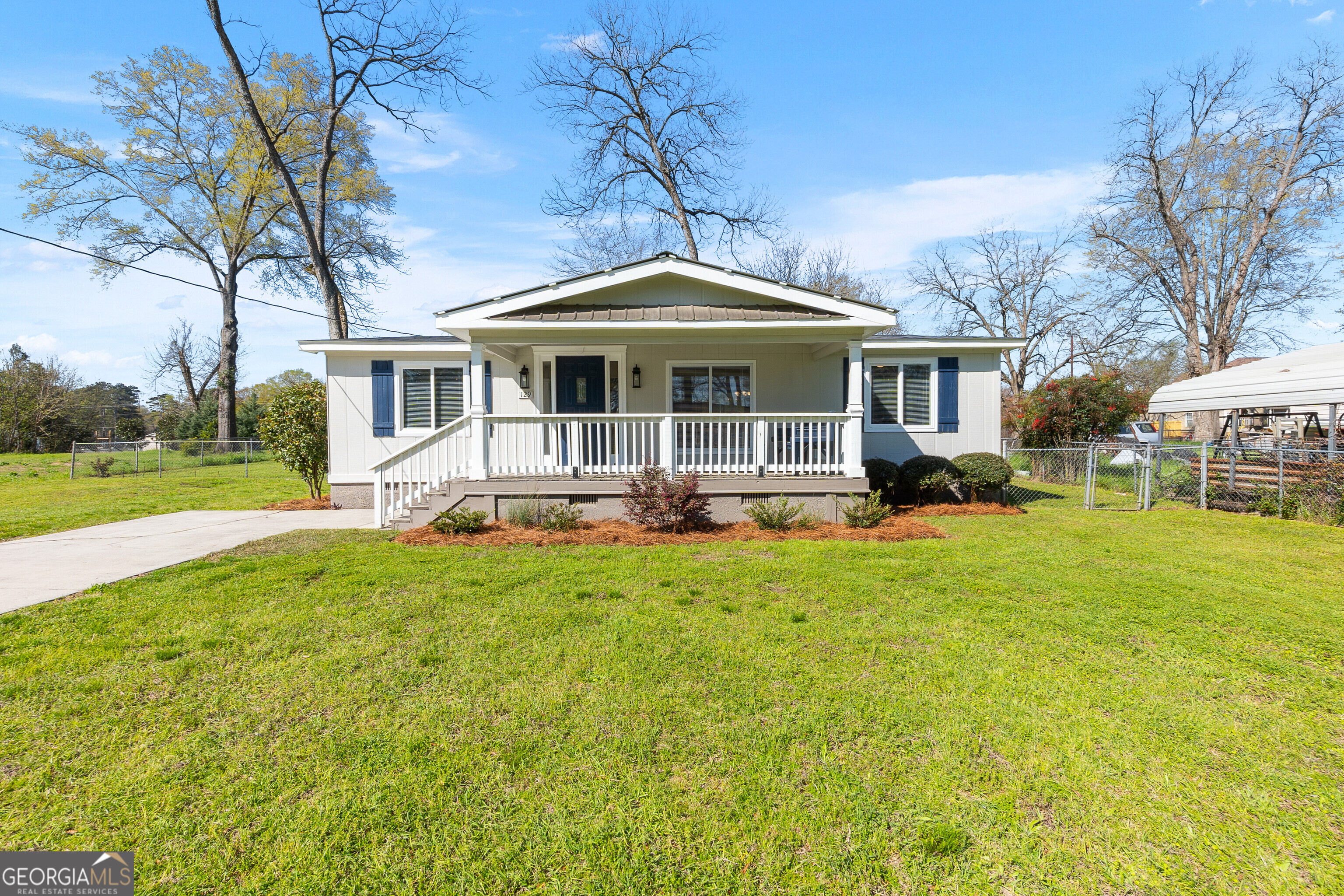 129 Walnut Street Bonaire, GA 31005 - Photo 1 of 31 a front view of a house with a yard