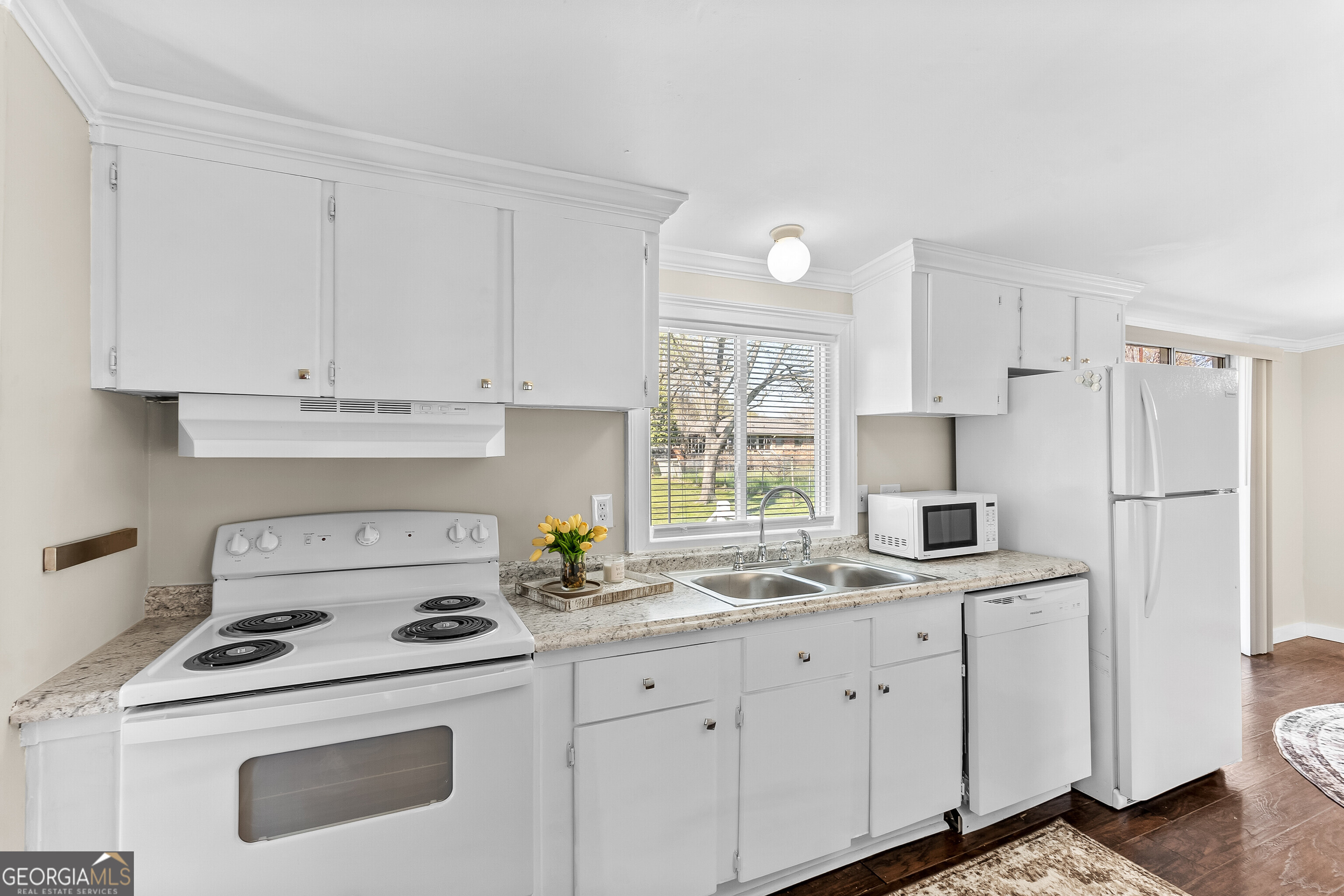 129 Walnut Street Bonaire, GA 31005 - Photo 11 of 31 a kitchen with appliances a sink and cabinets