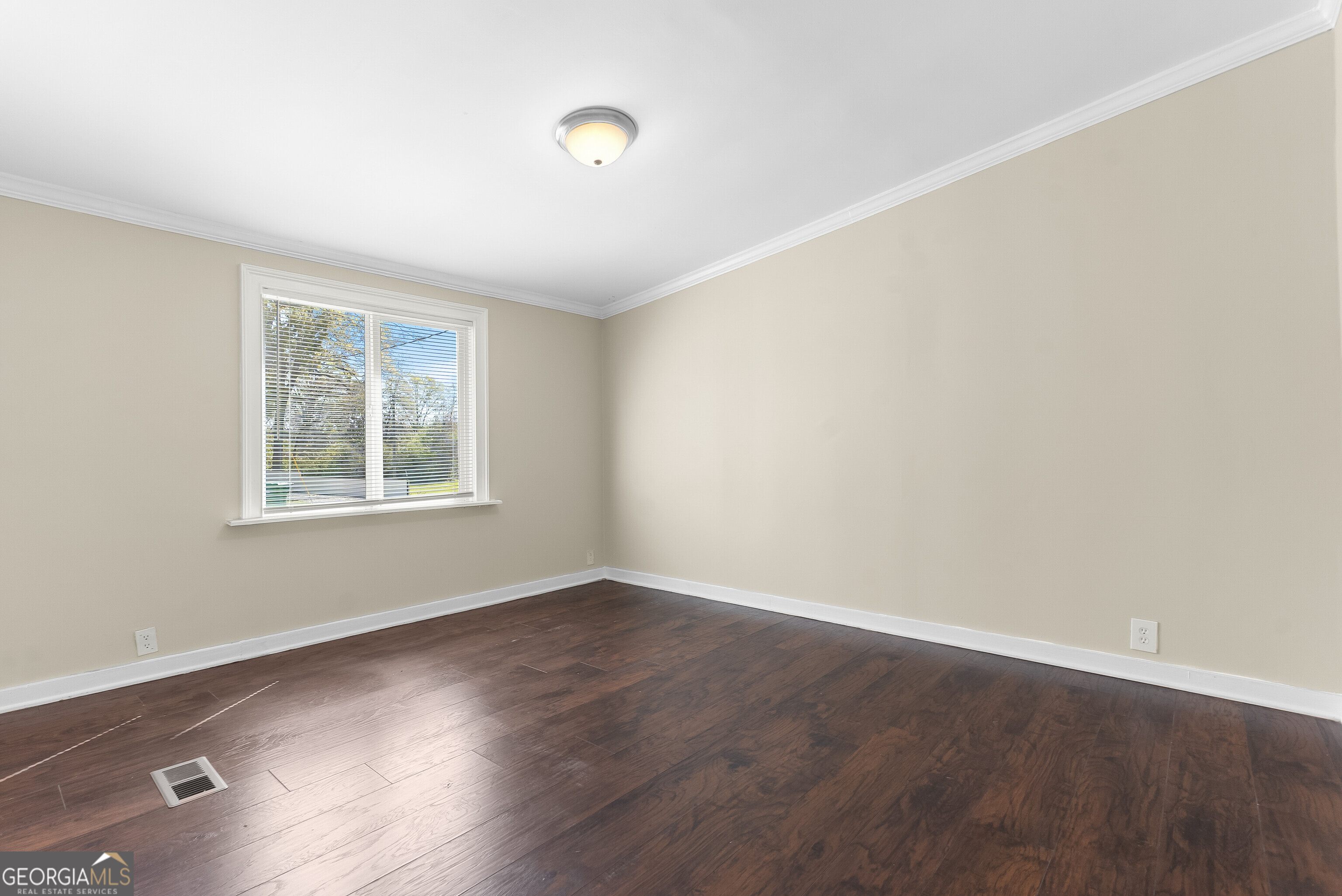 129 Walnut Street Bonaire, GA 31005 - Photo 16 of 31 an empty room with wooden floor and windows