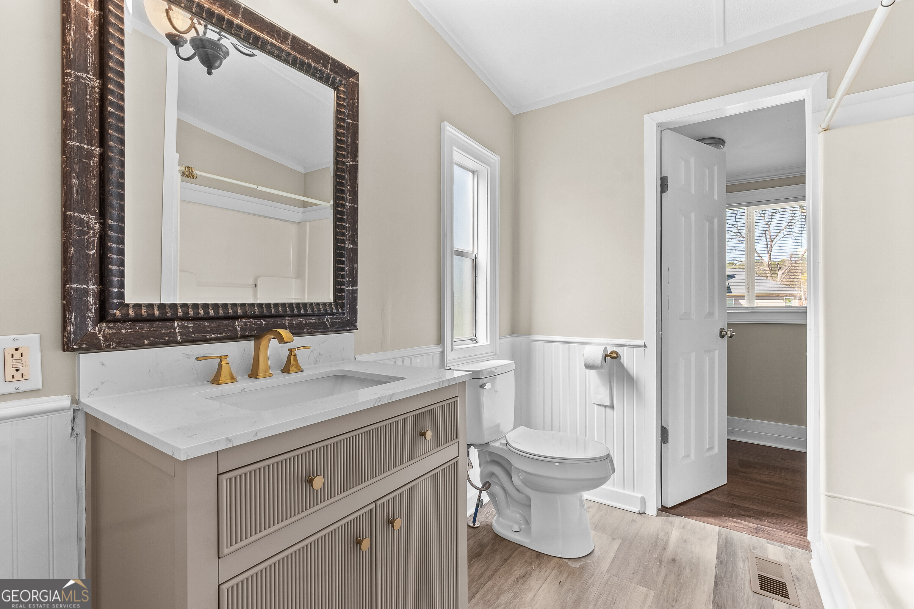 129 Walnut Street Bonaire, GA 31005 - Photo 19 of 31 a bathroom with a granite countertop toilet sink and a mirror
