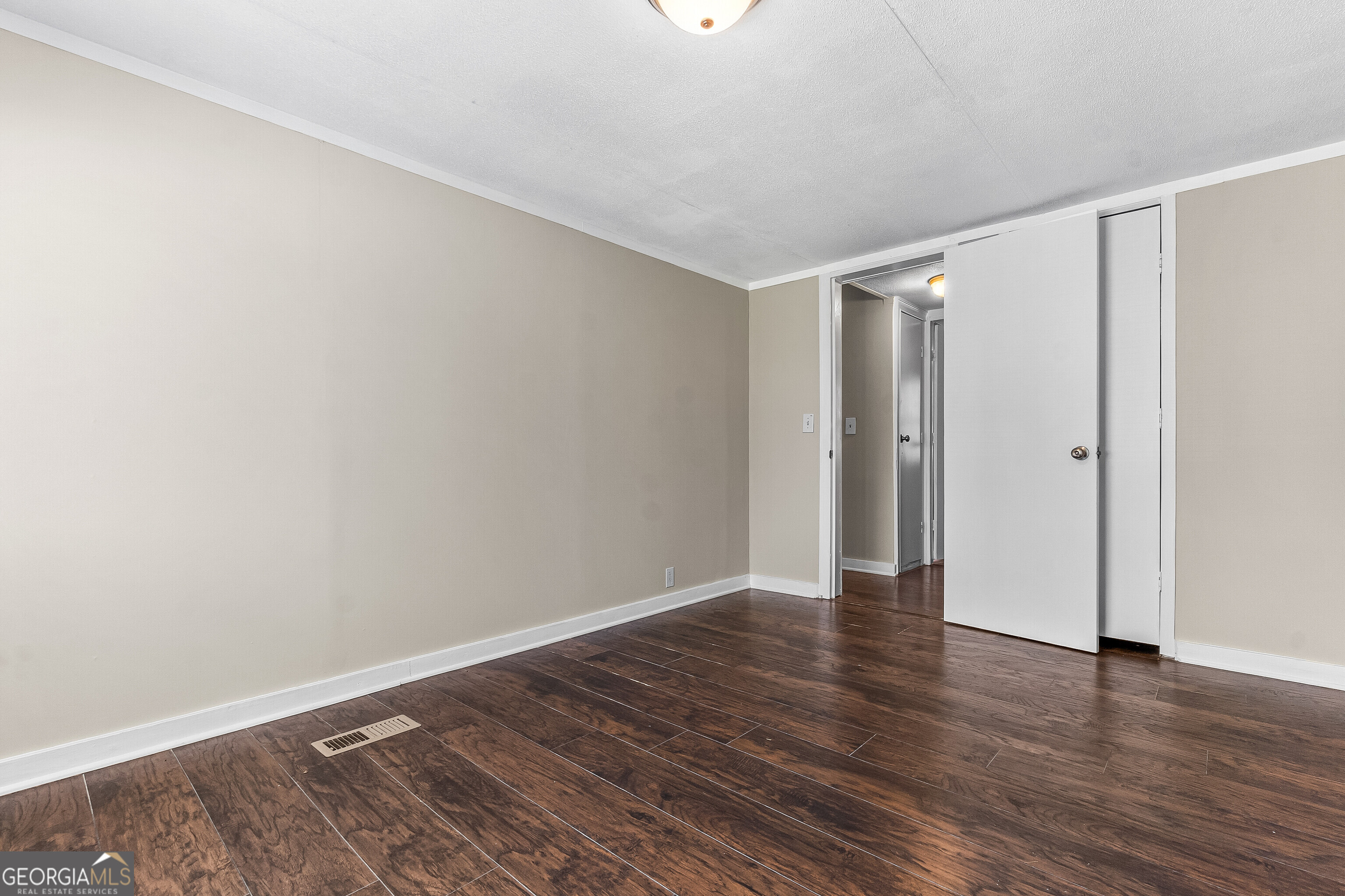 129 Walnut Street Bonaire, GA 31005 - Photo 22 of 31 a view of an empty room with wooden floor