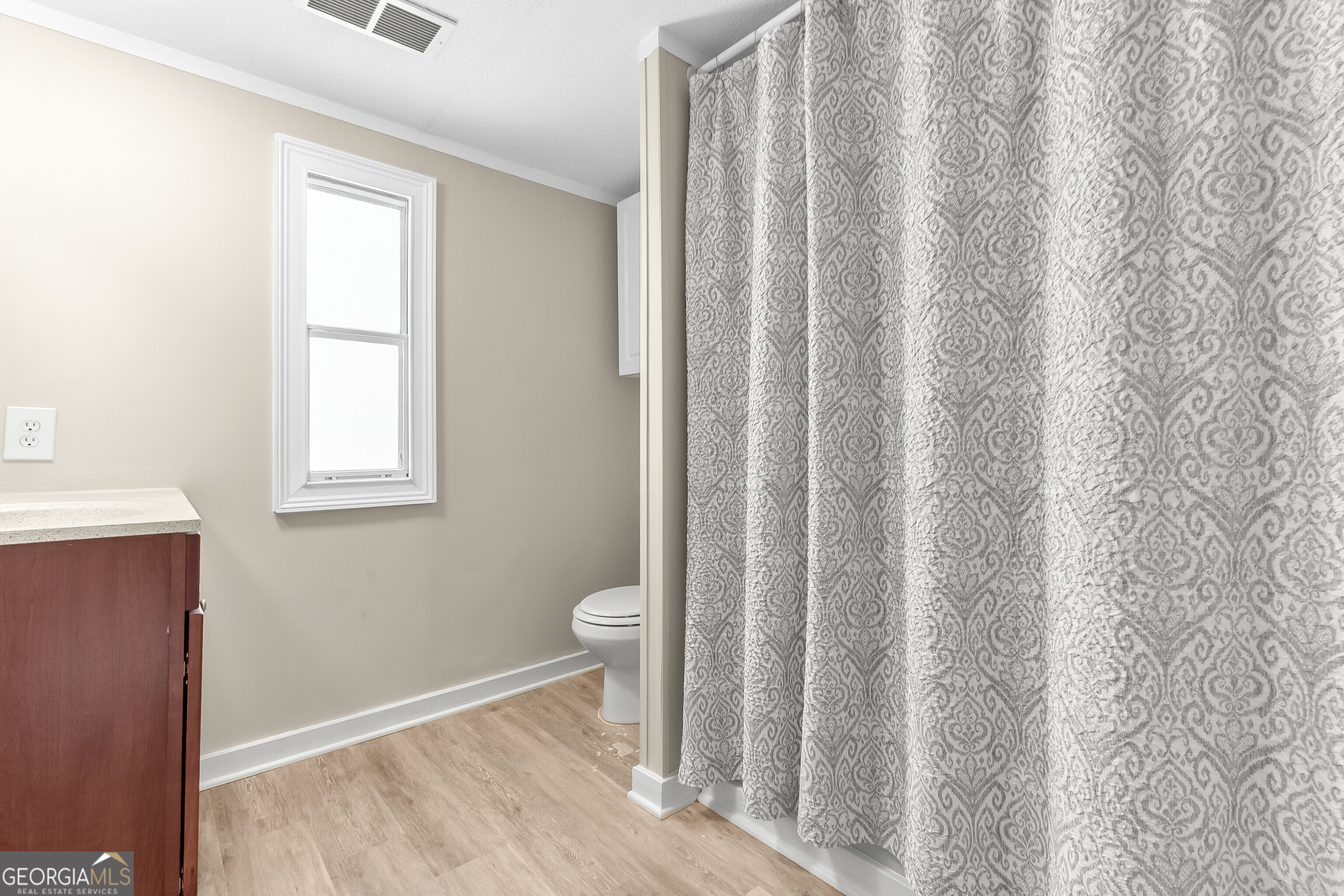 129 Walnut Street Bonaire, GA 31005 - Photo 24 of 31 a bathroom with a toilet and a window