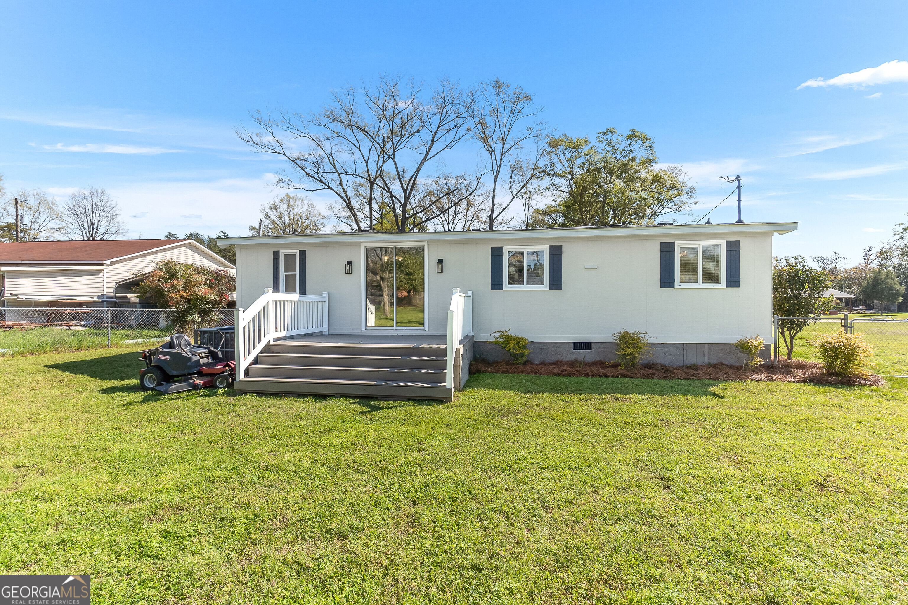 129 Walnut Street Bonaire, GA 31005 - Photo 27 of 31 a view of a house with patio and a yard
