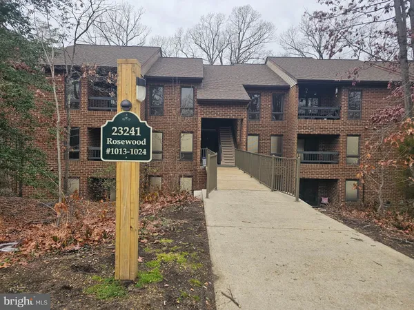 a street sign on a pole on a sidewalk