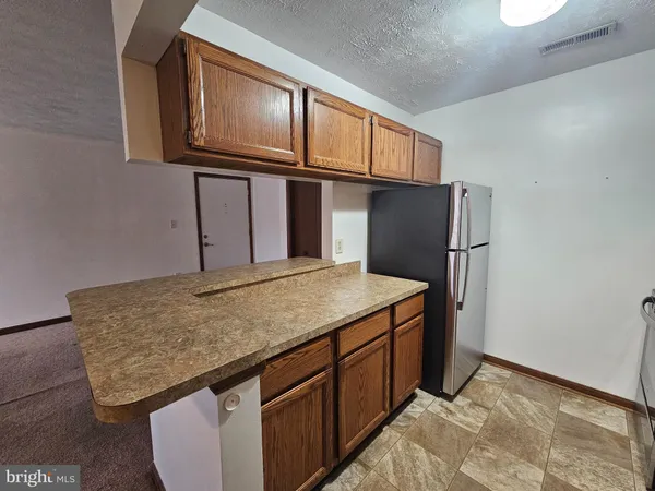 a kitchen with stainless steel appliances granite countertop cabinets and wooden floor