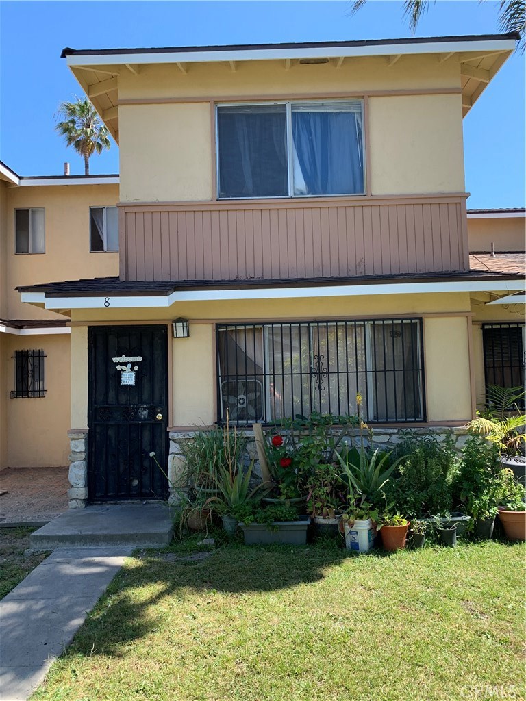 8 Palamino Lane Carson, CA 90745 - Photo 1 of 1 a view of a house with a small yard plants and large tree