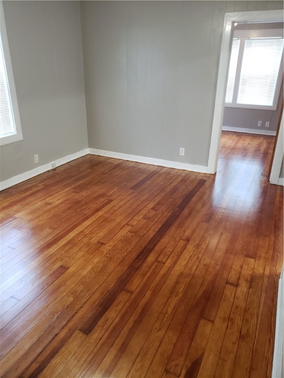 1806 2nd Street Corpus Christi, TX 78404 - Photo 7 of 7 an empty room with wooden floor and windows