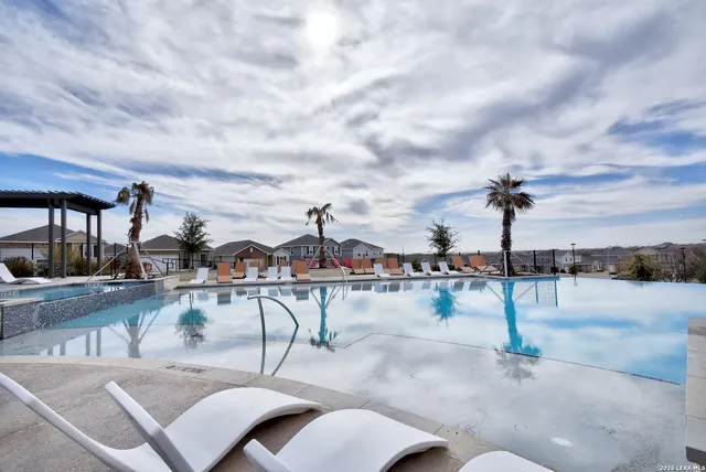 a view of a swimming pool with outdoor seating