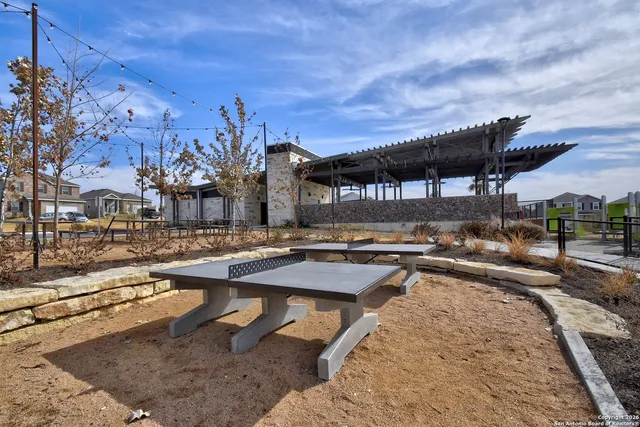 a view of a swimming pool with outdoor seating