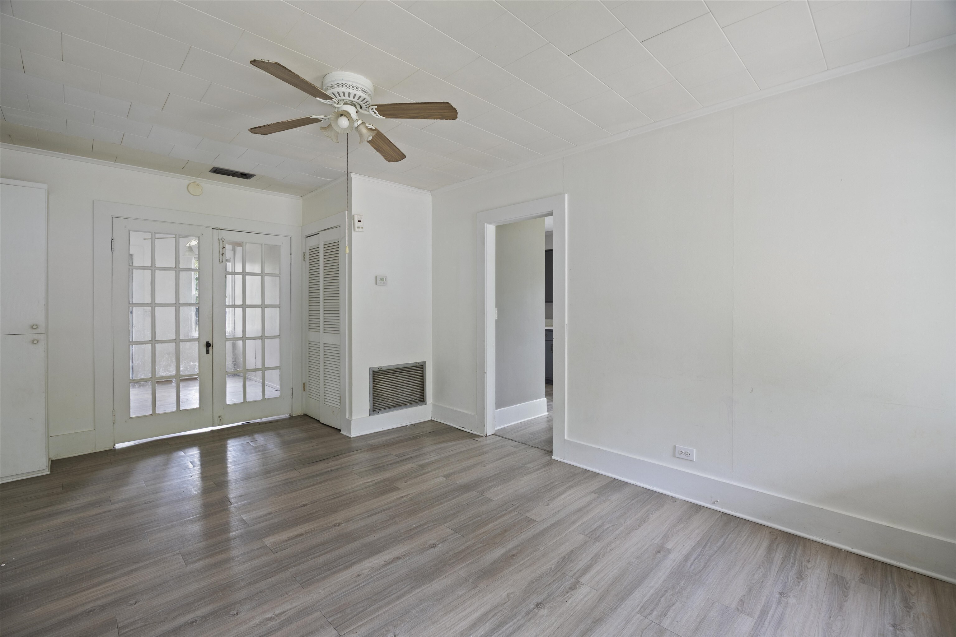 112 South Juniper Street Foley, AL 36535 - Photo 38 of 64 Unfurnished living room featuring a ceiling fan, wood finished floors, french doors, and ornamental molding