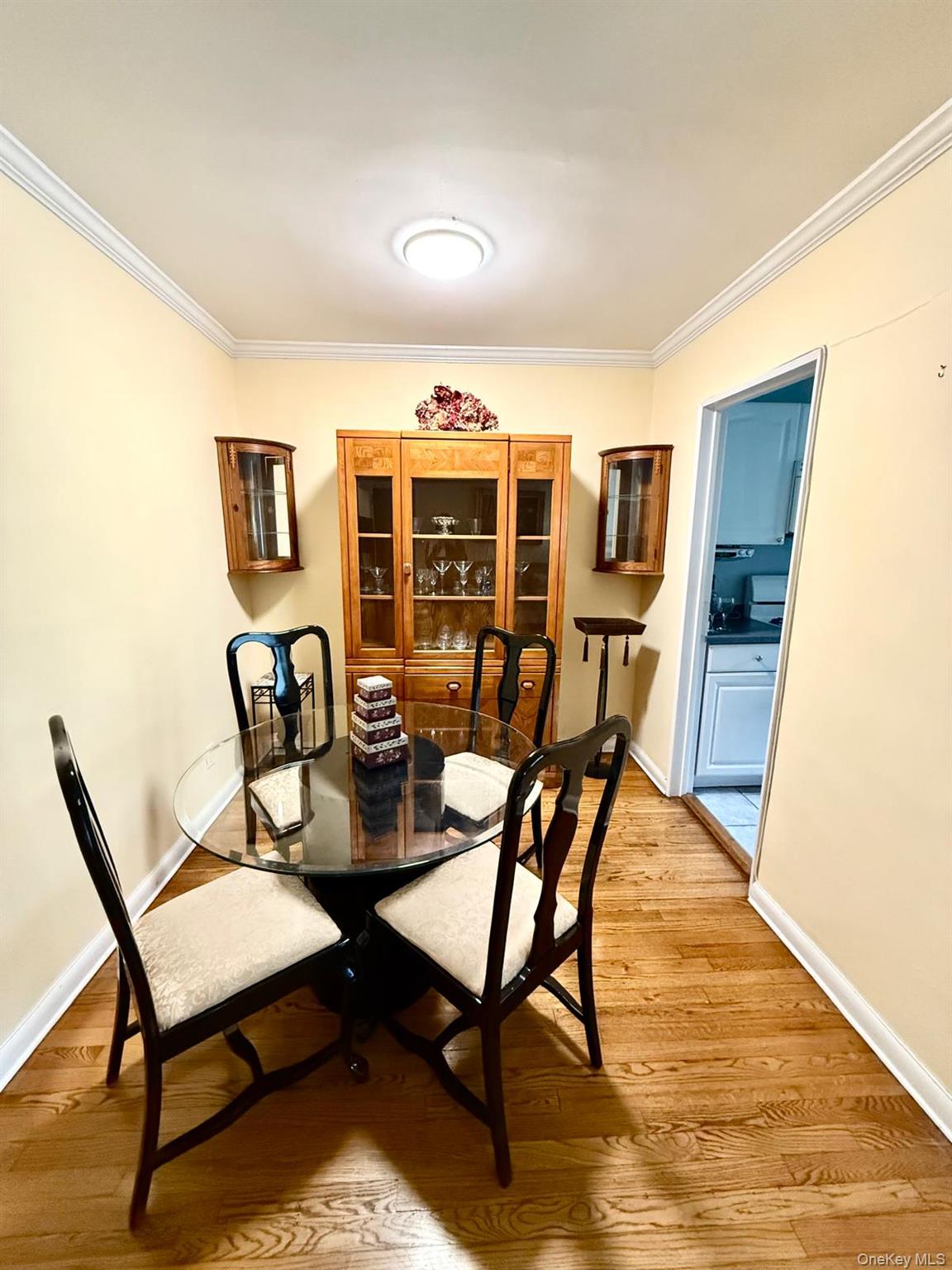 5805 251st Street, Unit 147 Queens, NY 11362 - Photo 4 of 7 a view of a dining room with furniture and wooden floor