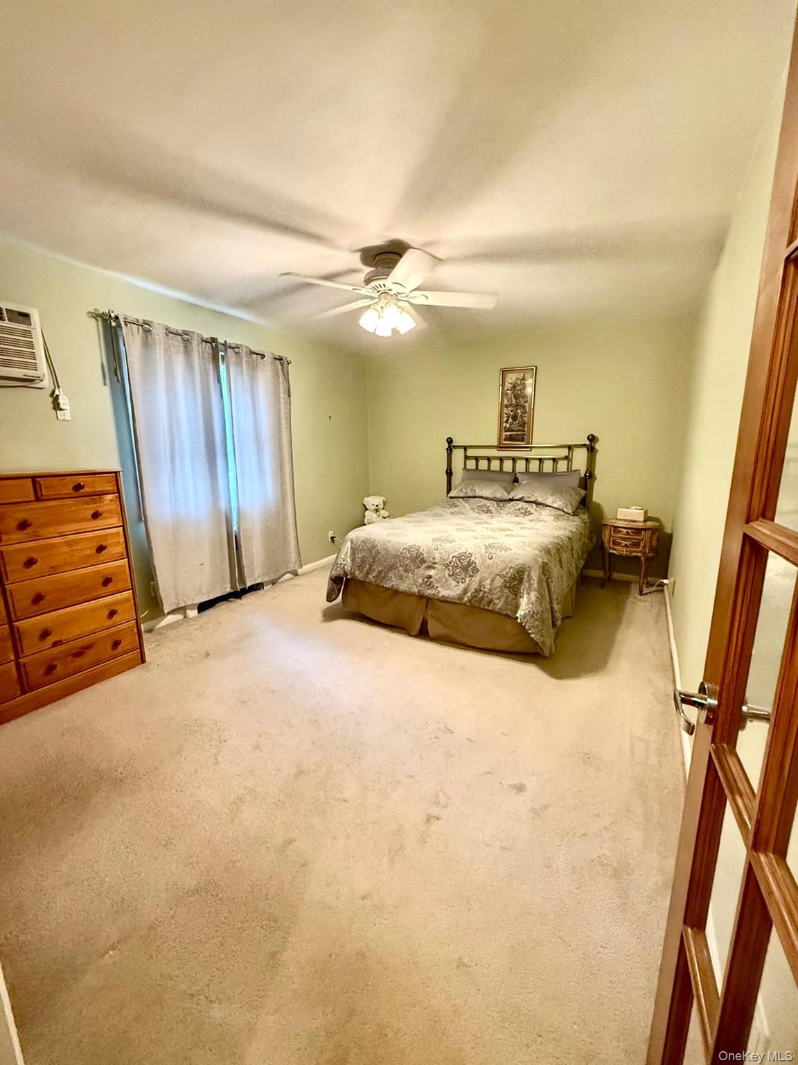 5805 251st Street, Unit 147 Queens, NY 11362 - Photo 5 of 7 a bedroom with a bed and a walk in closet