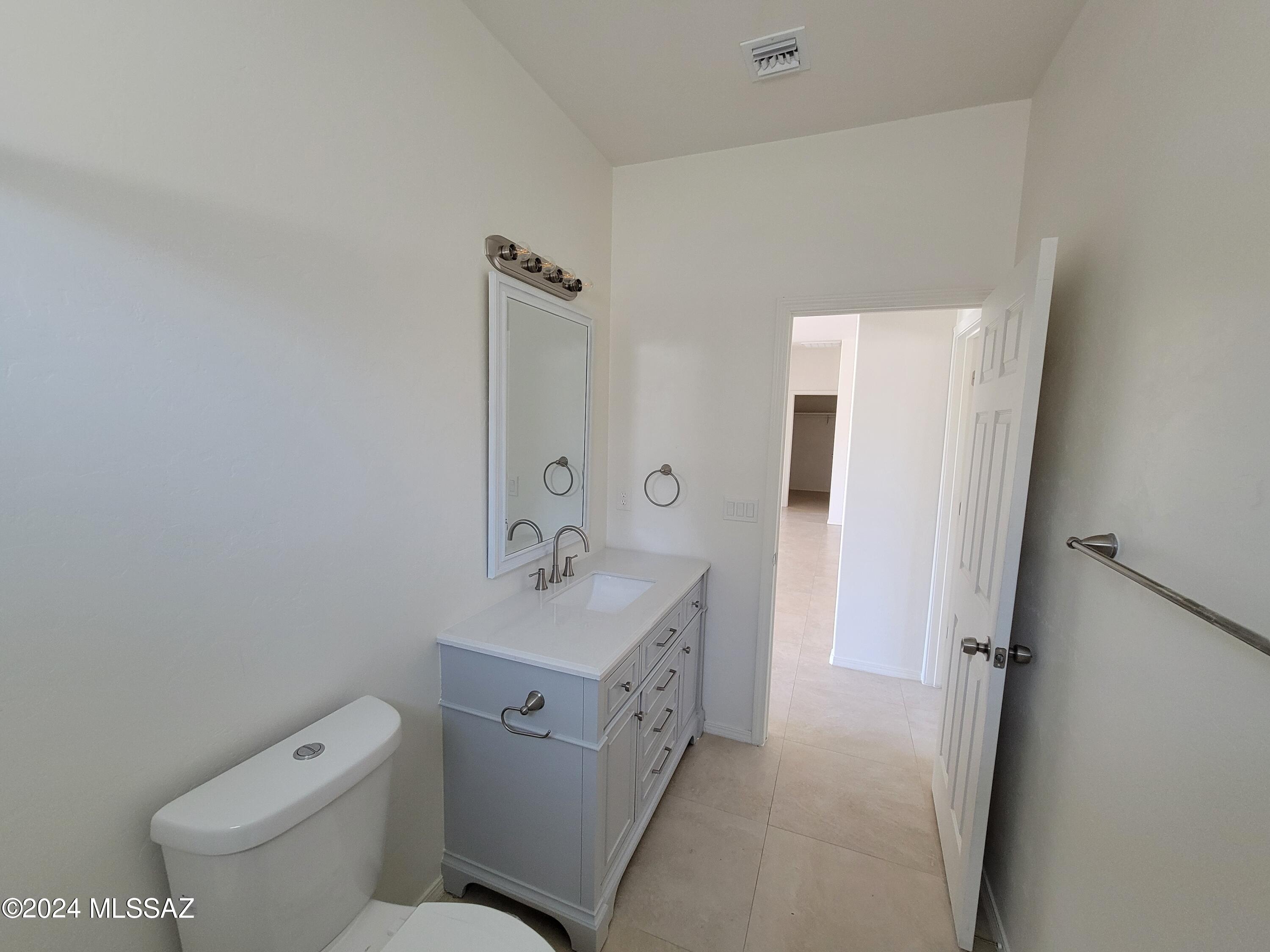 1763 Aguila Court Rio Rico, AZ 85648 - Photo 25 of 34 a spacious bathroom with a toilet sink and mirror
