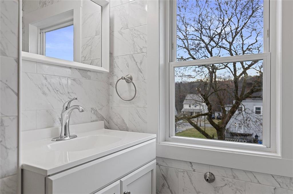 1809 Main Street Aliquippa, PA 15001 - Photo 13 of 24 a bathroom with a sink mirror and window