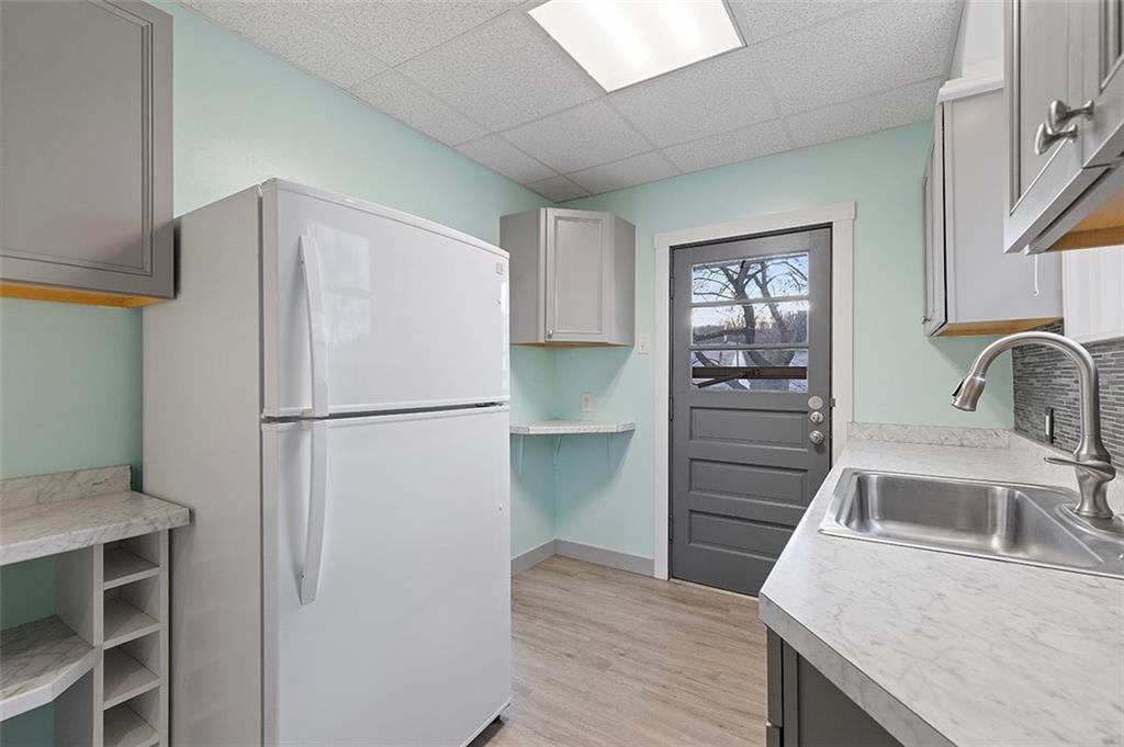 1809 Main Street Aliquippa, PA 15001 - Photo 9 of 24 a kitchen with a refrigerator sink and cabinets