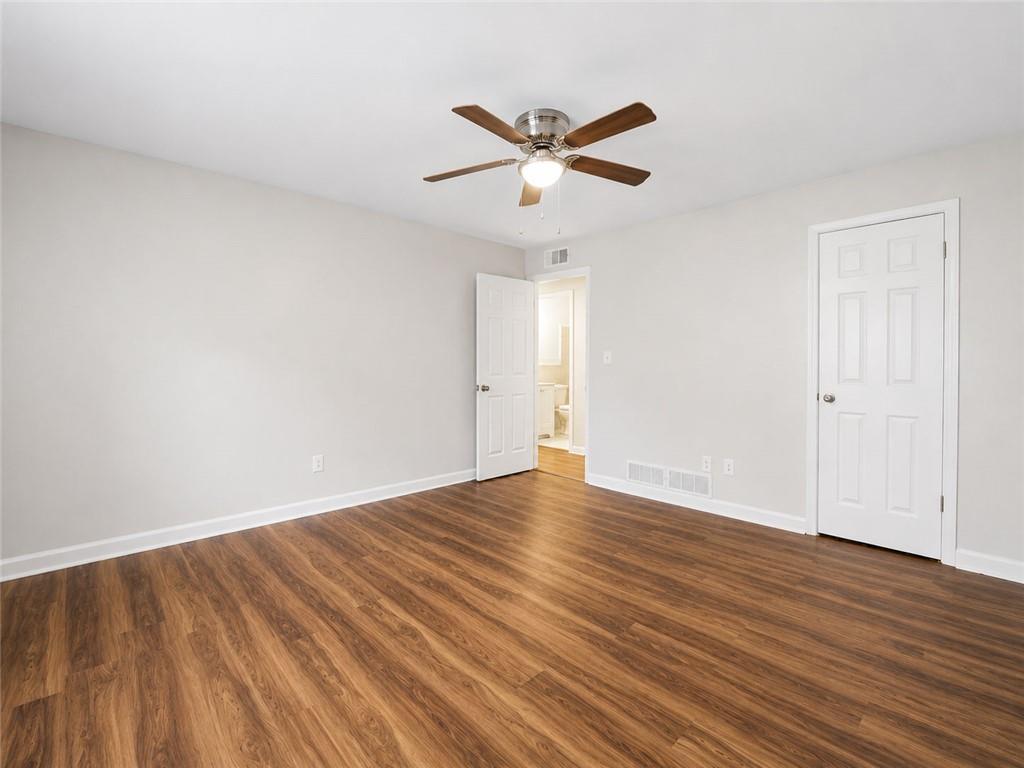 3193 East Point Street, Unit 4 Atlanta, GA 30344 - Photo 17 of 20 a view of an empty room with wooden floor and a ceiling fan