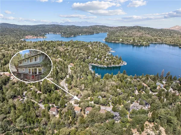 an aerial view of a house with a lake view