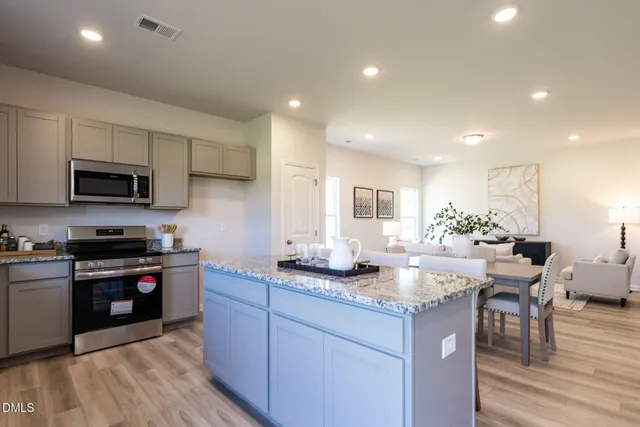a kitchen with granite countertop lots of counter top space and stainless steel appliances