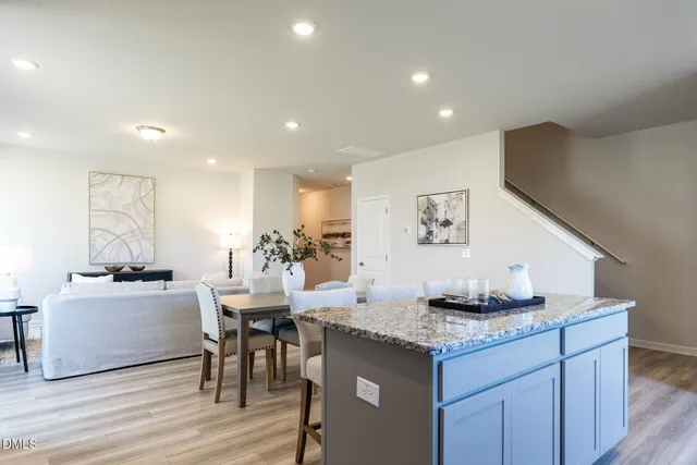a kitchen with granite countertop a table and chairs in it