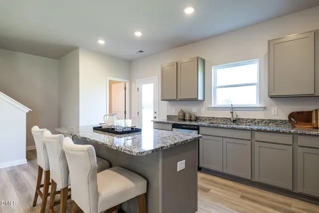 a kitchen with granite countertop a sink and cabinets