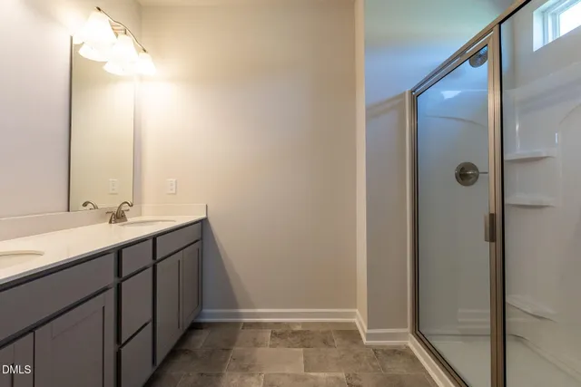 a bathroom with a double vanity sink and mirror