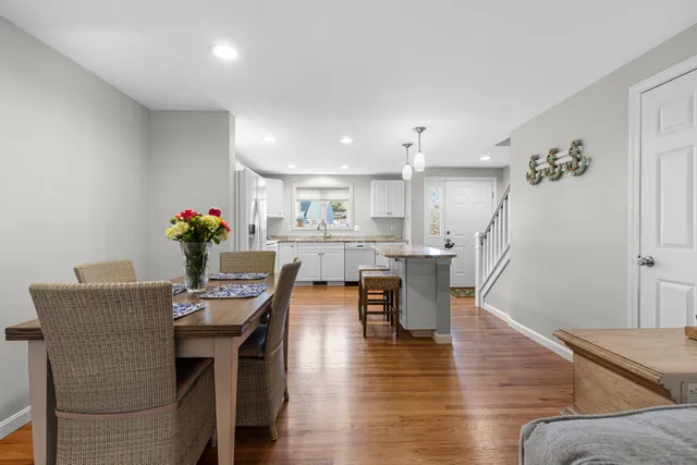 a dining room with furniture and wooden floor
