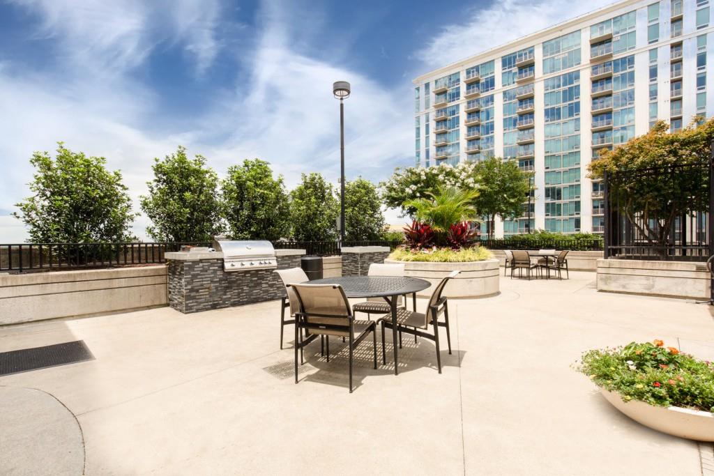 250 Pharr Road Northeast, Unit 216 Atlanta, GA 30305 - Photo 33 of 38 a view of a swimming pool with outdoor seating