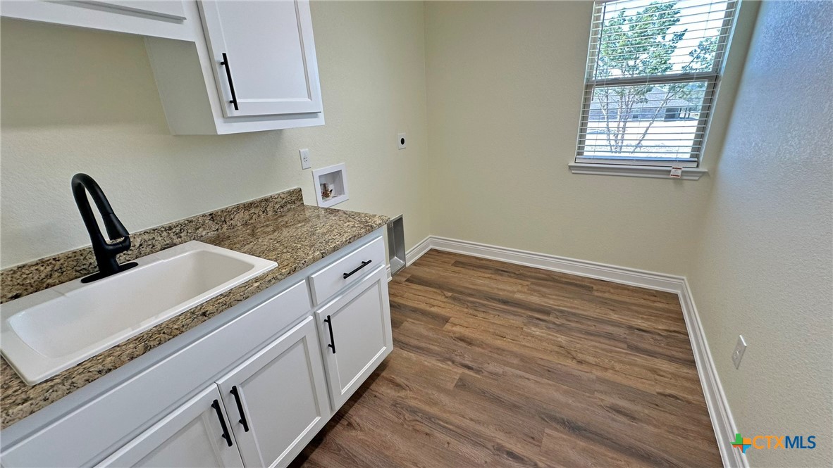 4237 Cool Basin Road Kempner, TX 76539 - Photo 18 of 36 a kitchen with granite countertop a stove and a sink